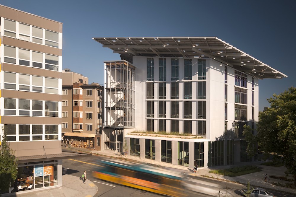 Image of the Bullitt Centre, a five-storey white building with an overhanging roof.